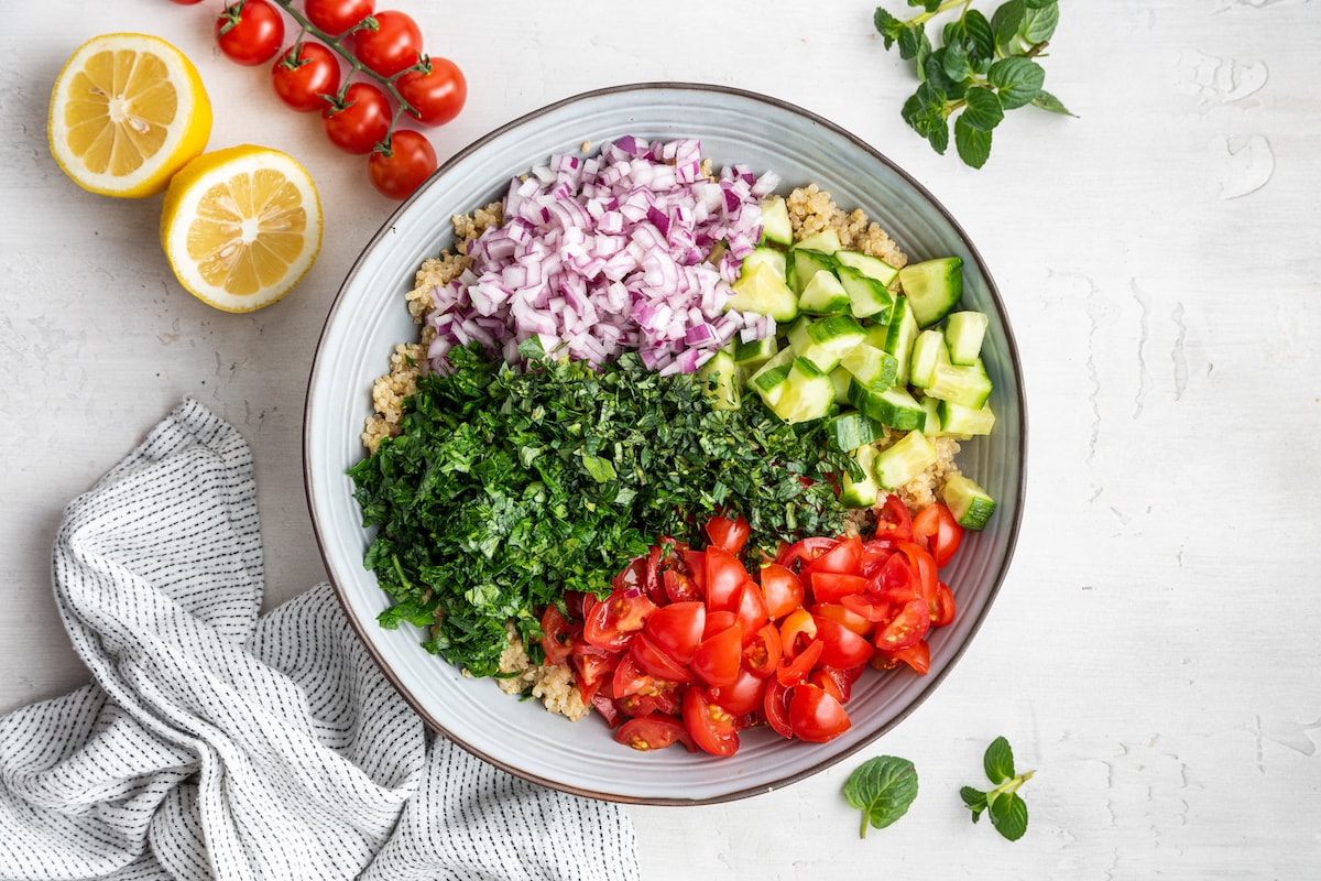 Ingredients for quinoa tabbouleh in a serving bowl.