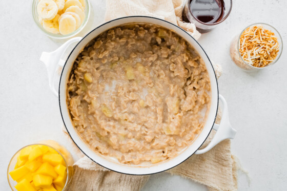 Cooked oatmeal mixed together in a pot.