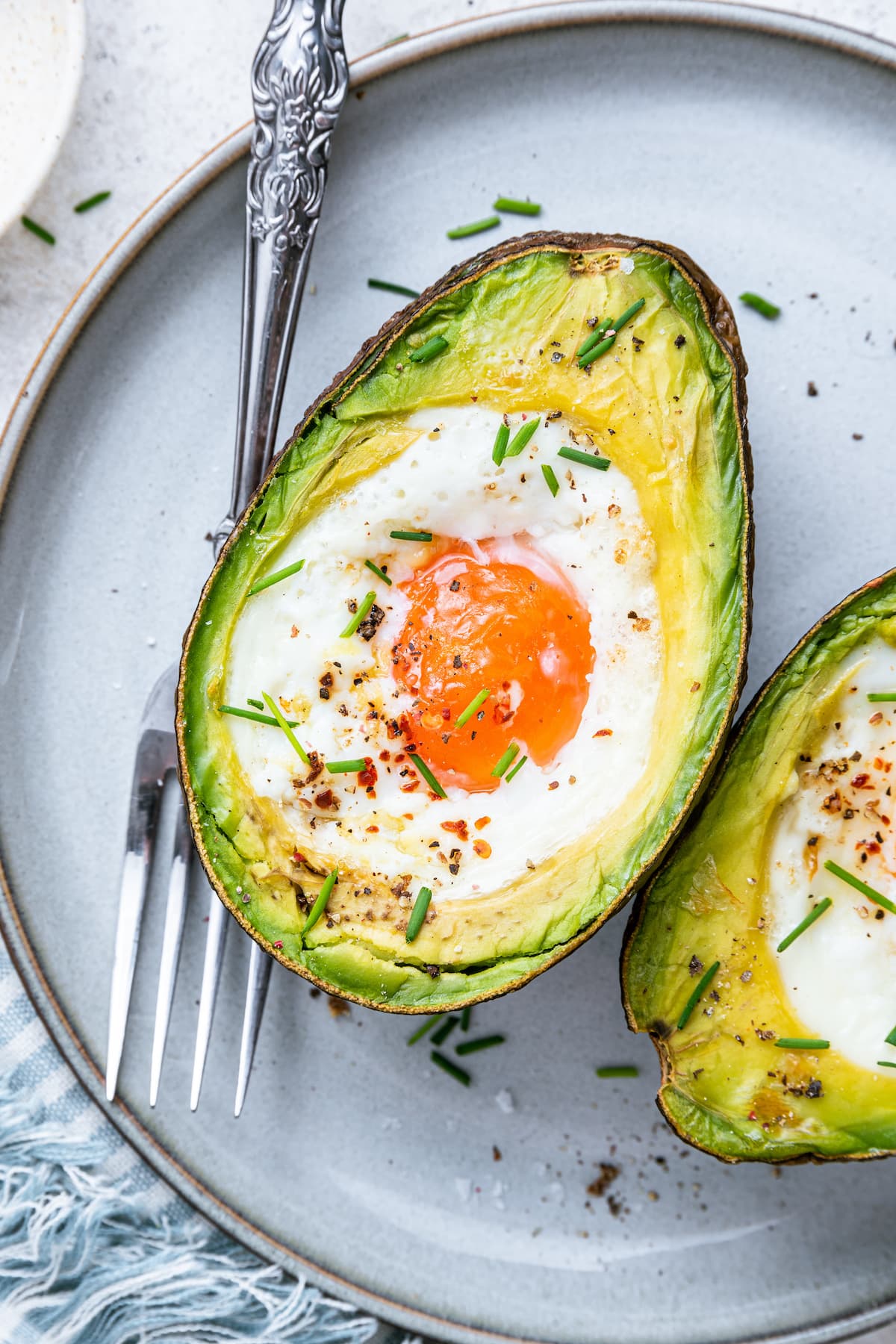 Good Morning Richmond with Darrielle Snipes A baked avocado with an egg in the center on a plate with a fork.