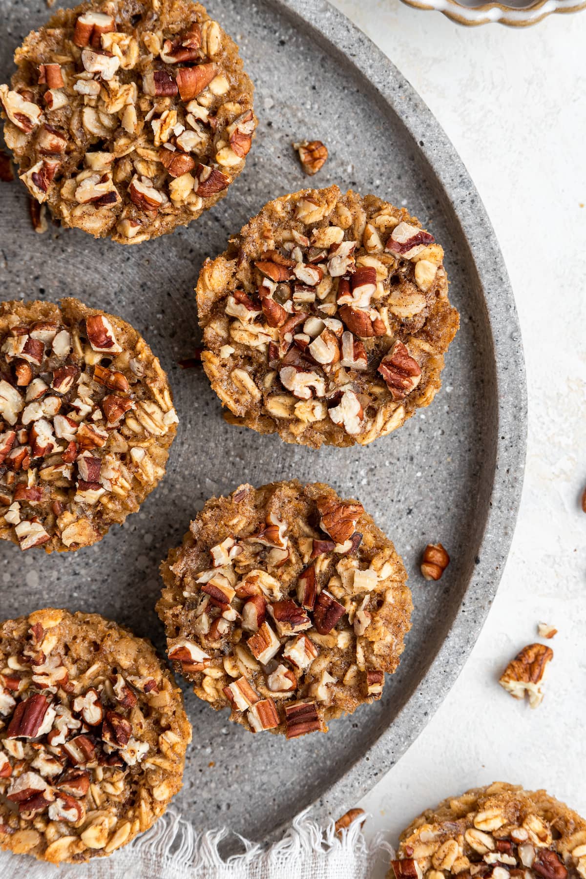 HEALTHY Baked Chai Oatmeal Cups. You’ll love how easy they are to make and the cozy chai flavor. Chai baked oatmeal cups on a gray plate.