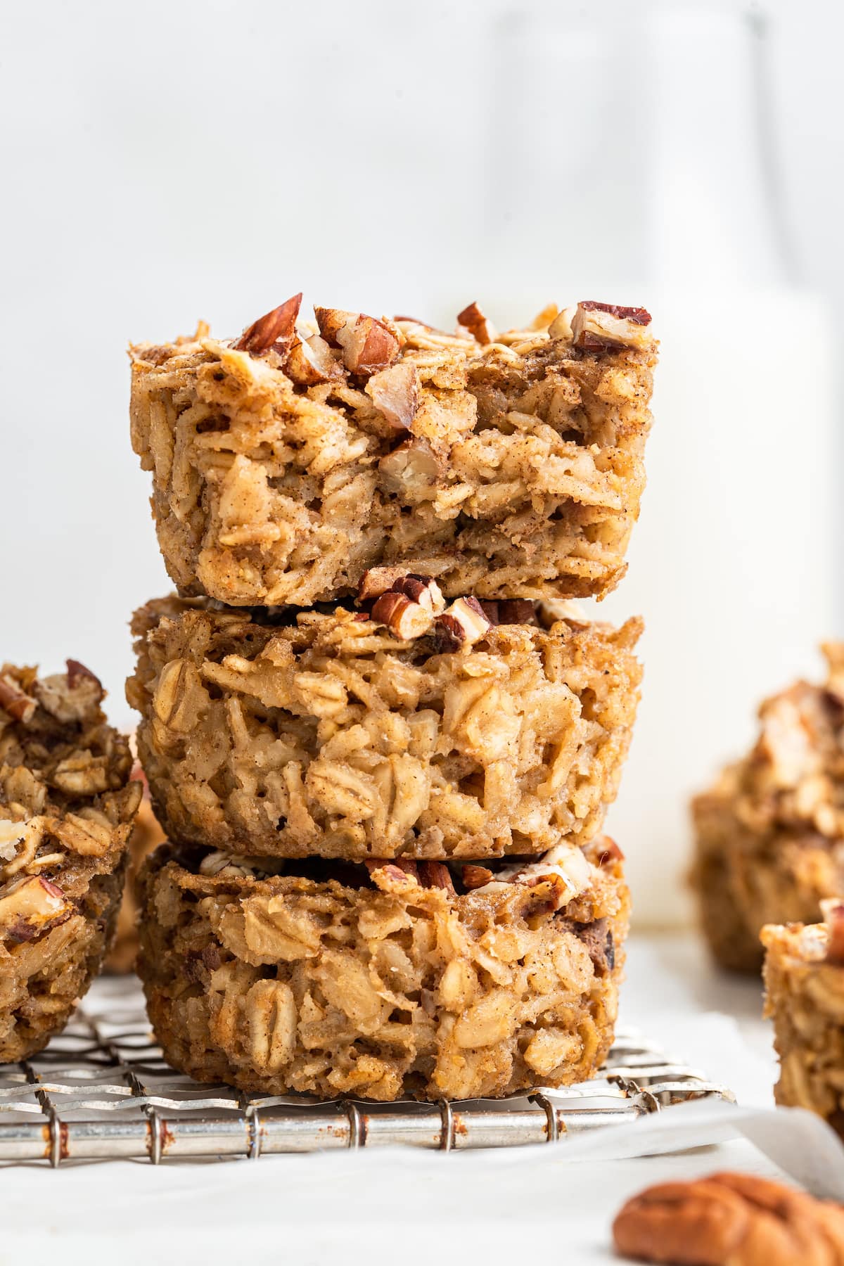 HEALTHY Baked Chai Oatmeal Cups. You’ll love how easy they are to make and the cozy chai flavor. Three chai baked oatmeal cups stacked on one another. The one on top has a bite taken out of it.