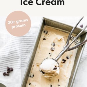 Ice cream scoop scooping cottage cheese ice cream from loaf pan.