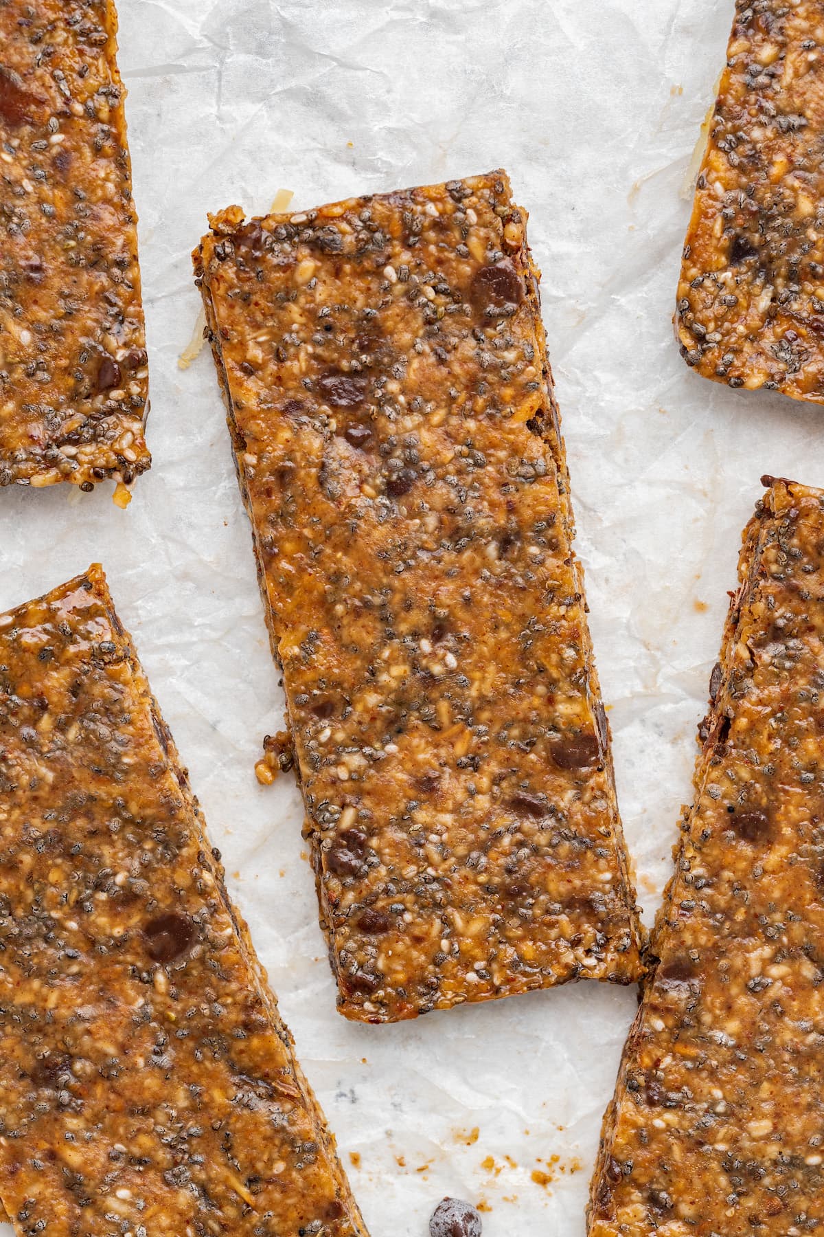 Toasted coconut chia bars made with 7 simple ingredients. A close-up of a coconut chia bar near four more.