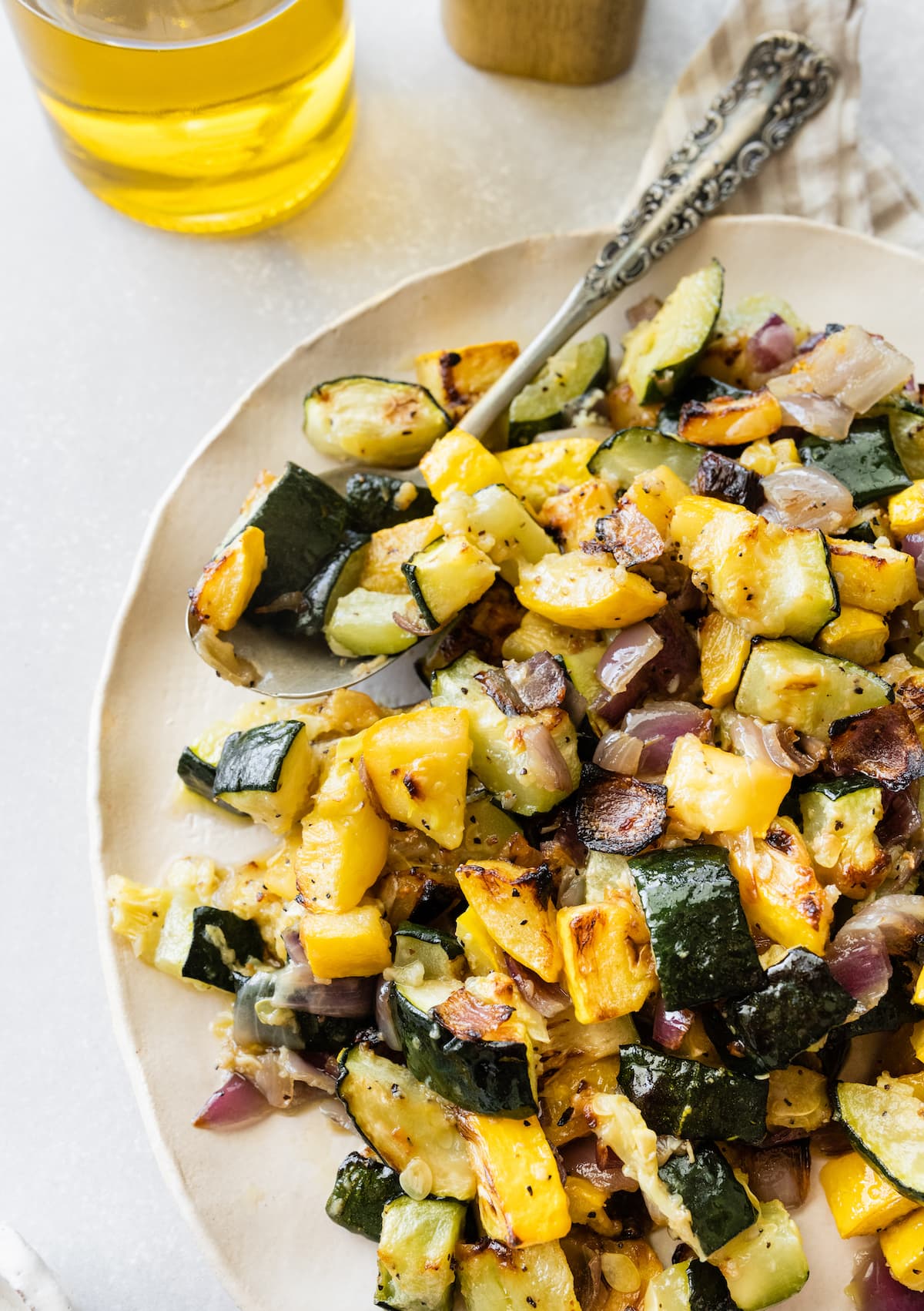 A serving of roasted zucchini and squash on a plate.