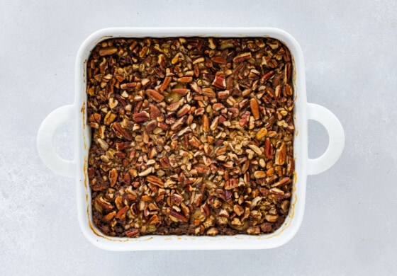 Baked oatmeal in a square white baking dish after it's been baked.