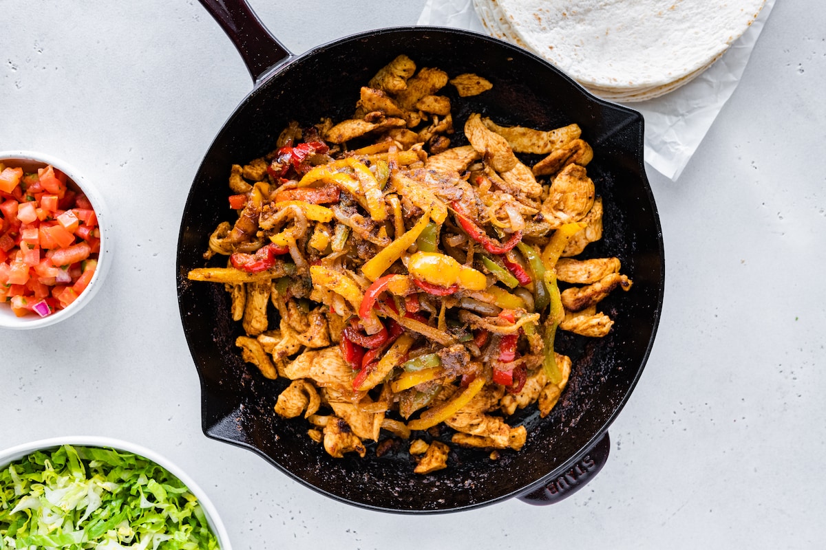 Chicken fajita mix in a cast iron skillet.