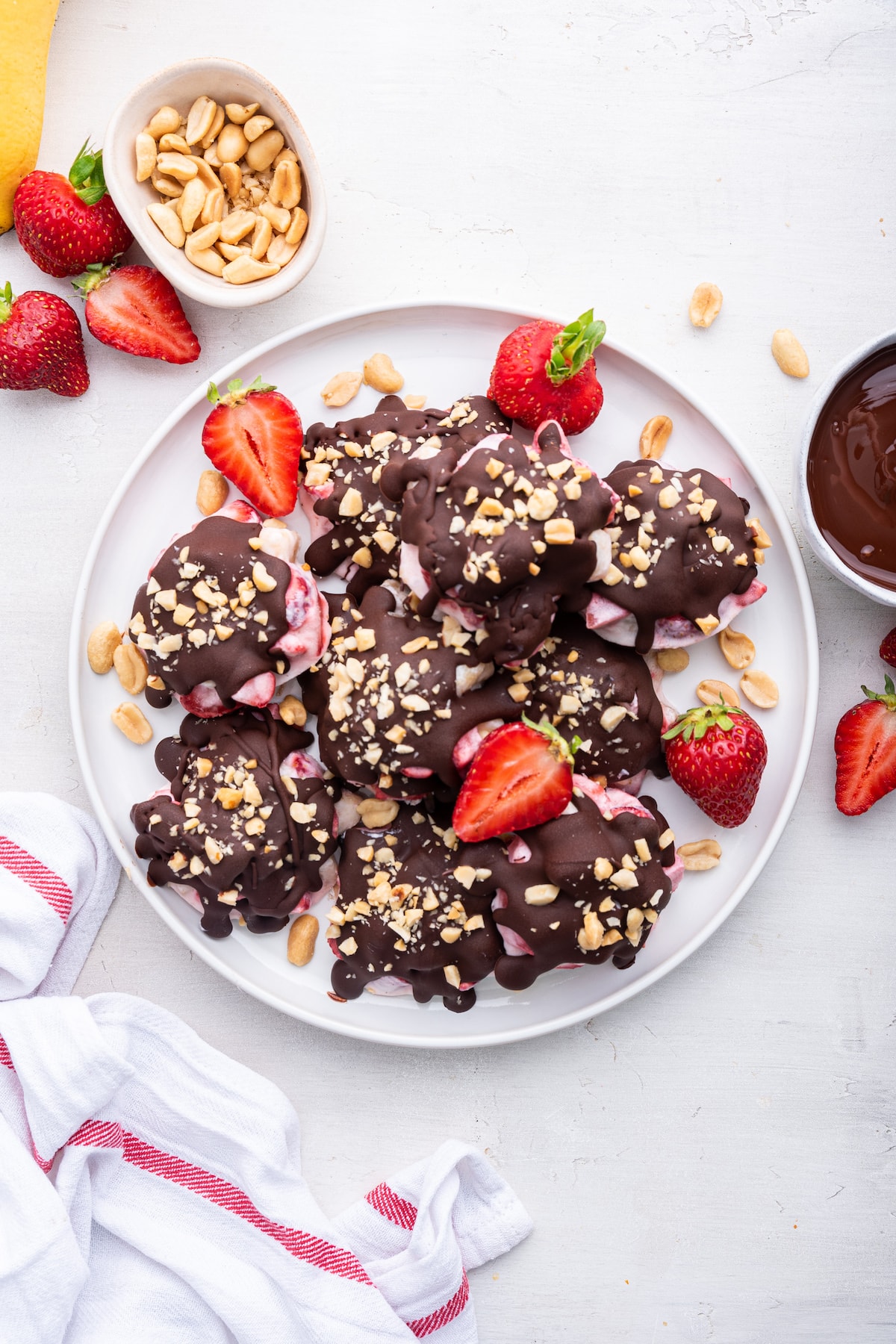 Chocolate strawberry banana yogurt clusters on a large white plate.