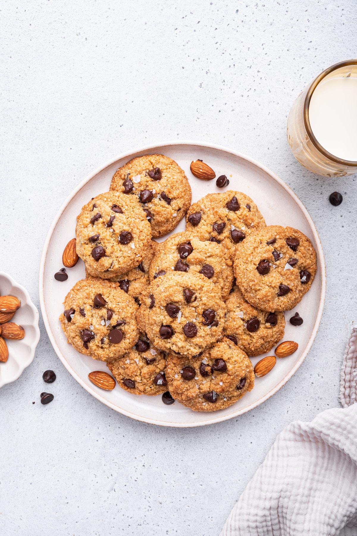 Multiple almond flour chocolate chip cookies on a large plate.