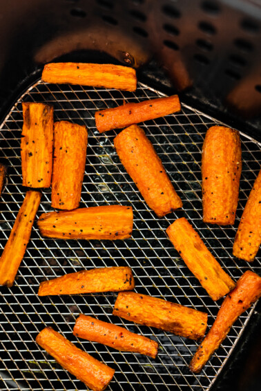 Carrots cut into matchsticks in an air fryer.