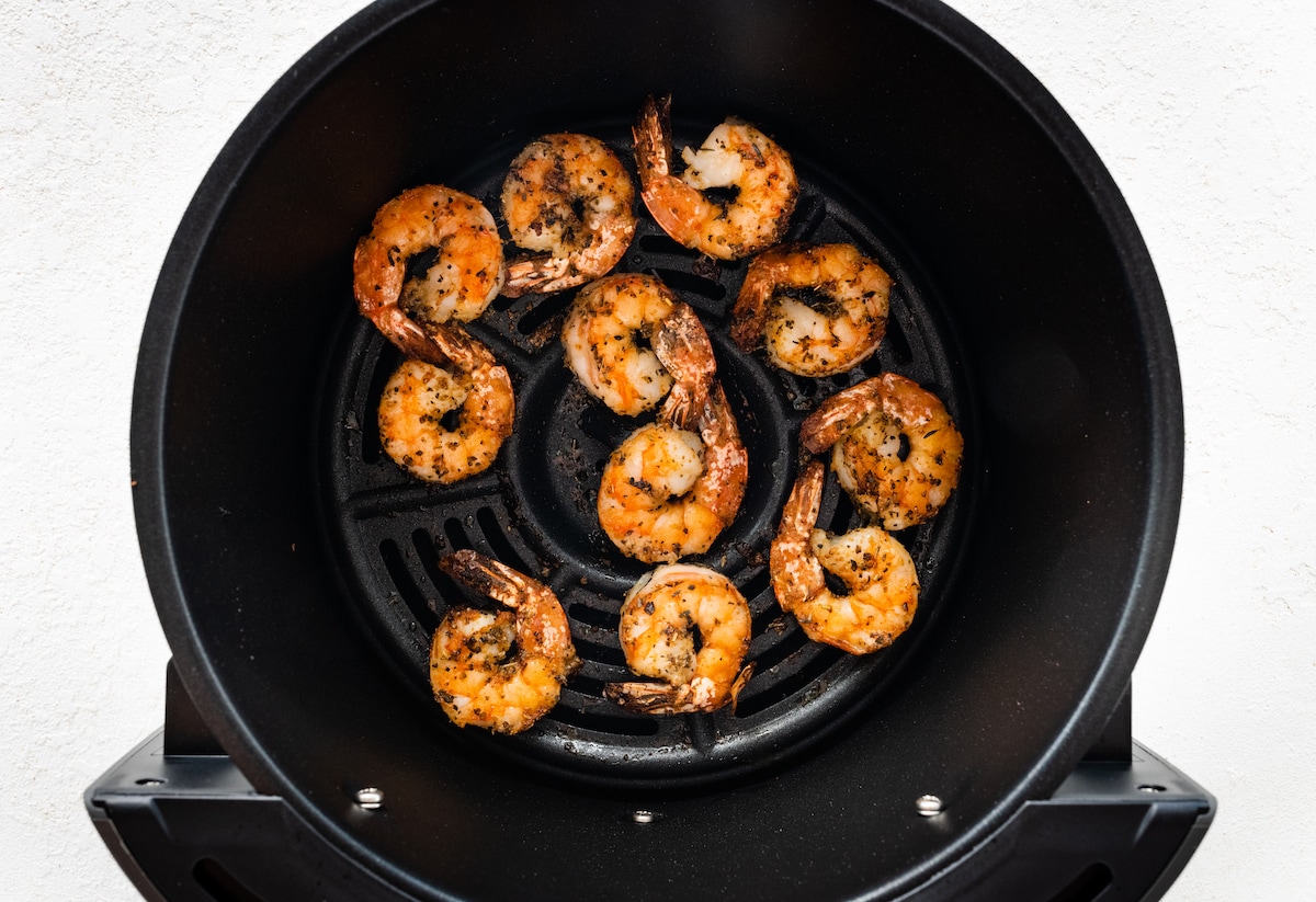 Air-fried shrimp in an air fryer basket.