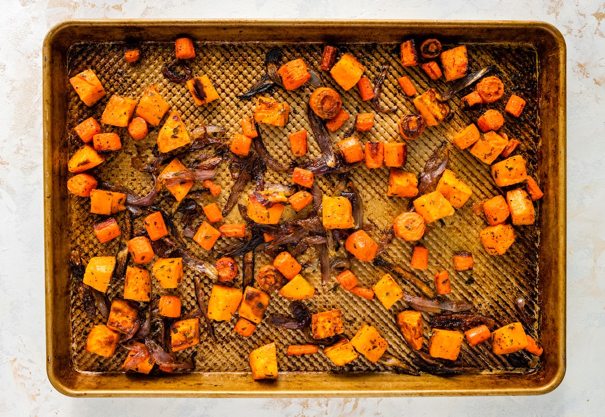 Roasted root vegetables on a baking sheet.