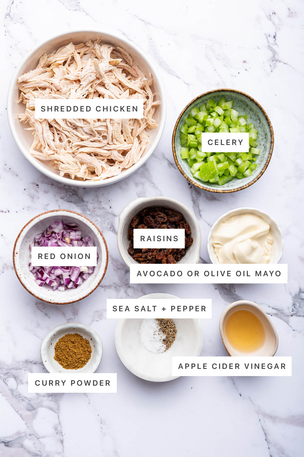 Ingredients used for curry chicken salad include: shredded chicken, celery, raisins, mayo, red onion, sea salt, pepper, vinegar, and curry powder.