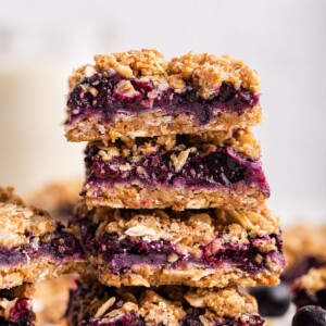 Blueberry crumble bars stacked on one another.