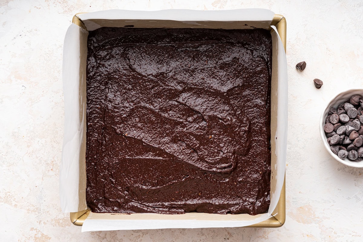 A square baking dish of uncut avocado brownies.