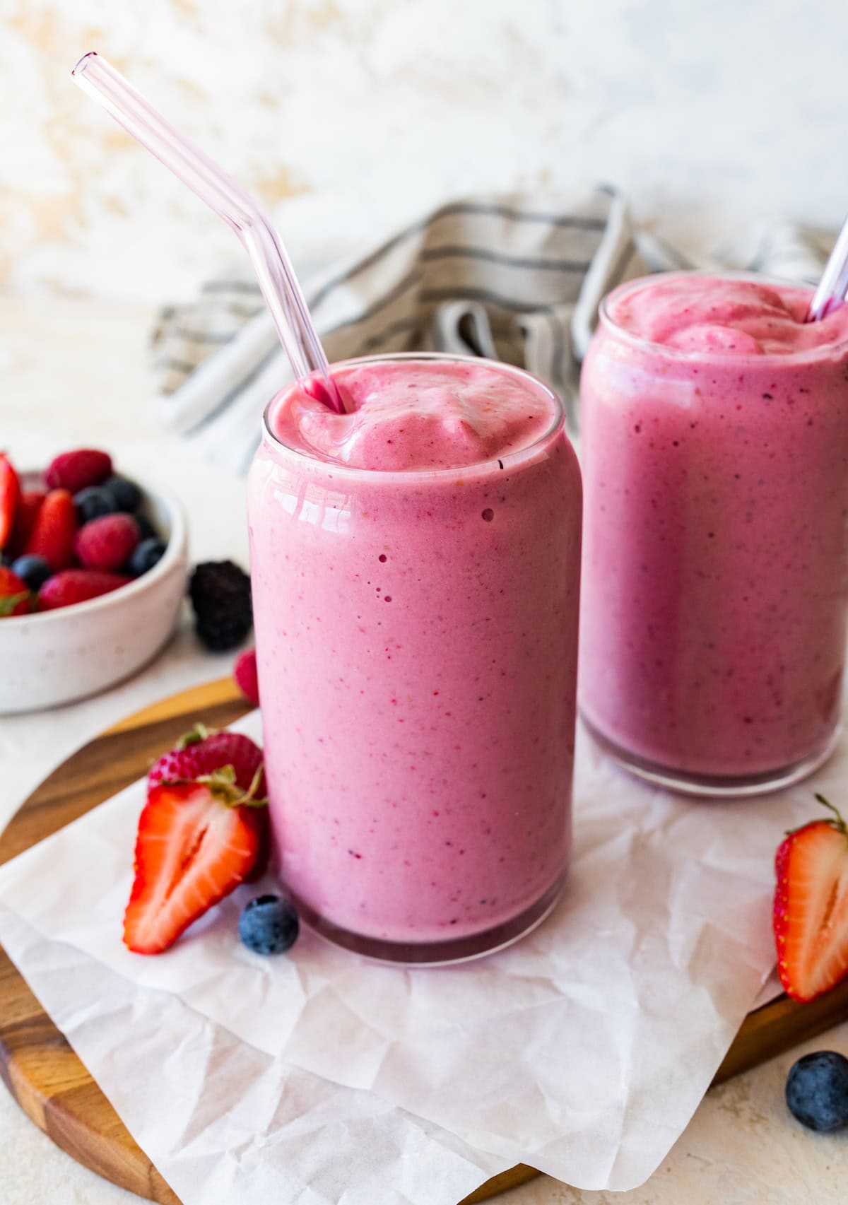 Two glasses filled with the kefir smoothie. Both glasses have a straw.