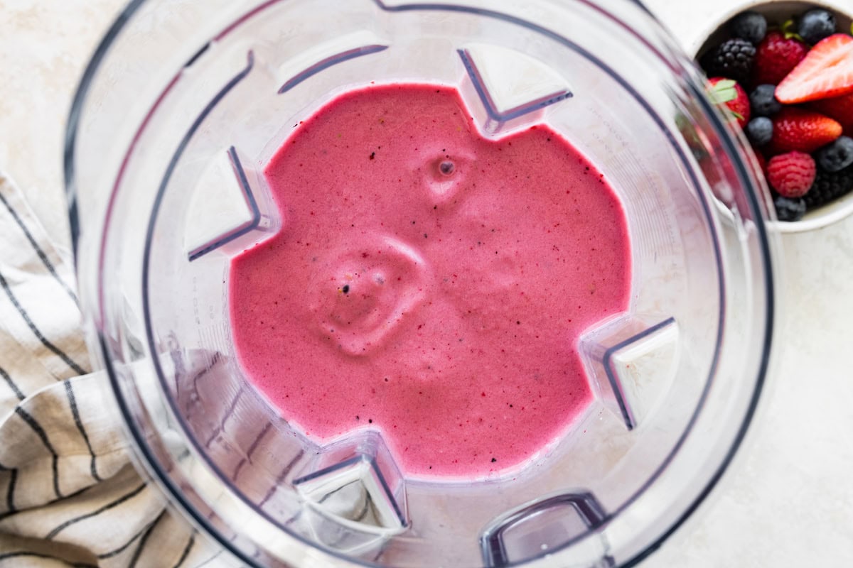 Blended berry kefir smoothie in the base of a blender.