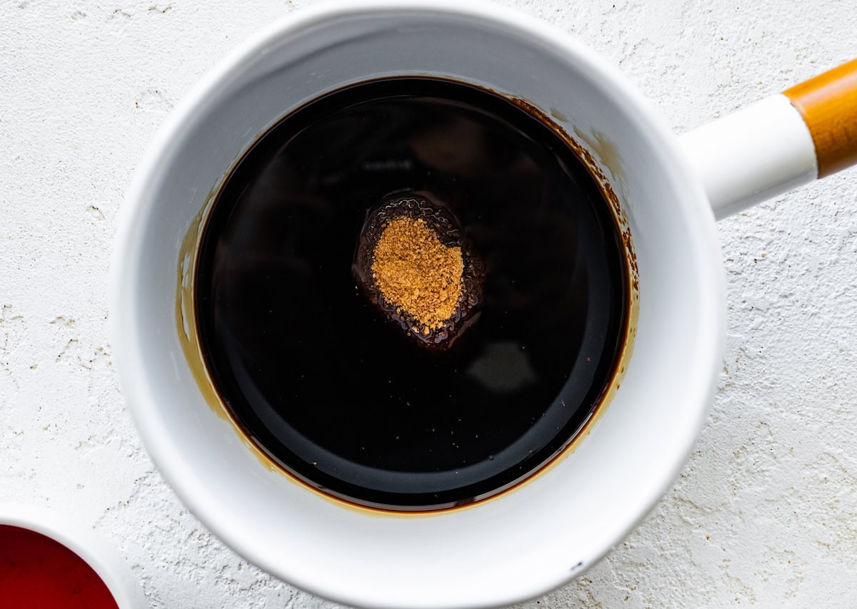 A saucepan with balsamic vinegar and coconut sugar.