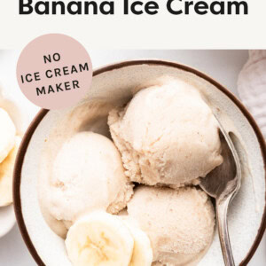 Bowl of banana ice cream topped with a couple slices of banana.