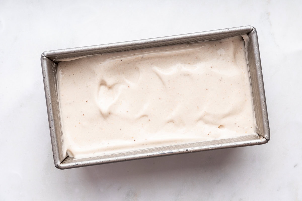 Banana ice cream in a rectangular metal container.