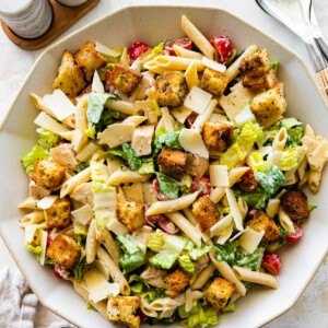 Chicken caesar pasta salad in a large bowl.