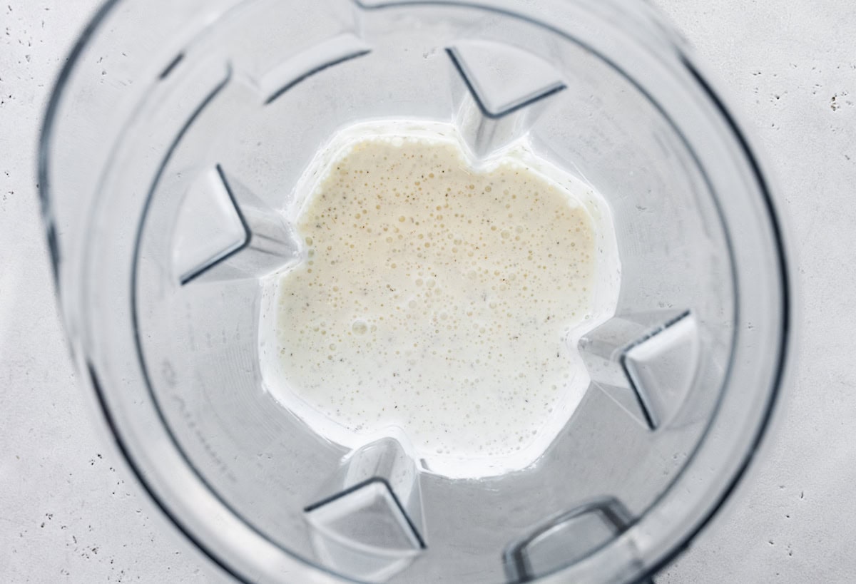 The blended cottage cheese wrap mixture in the base of a blender.