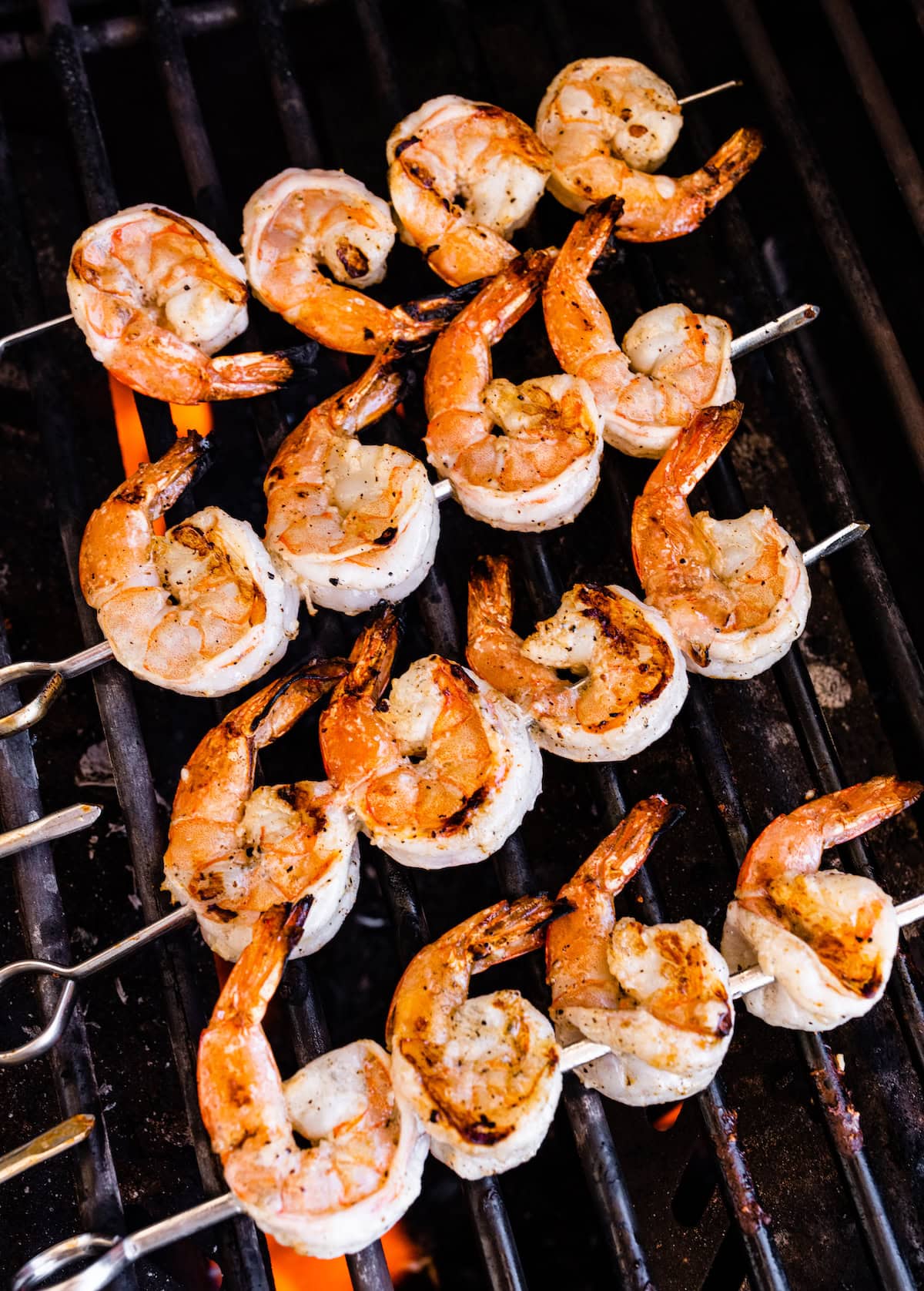 Grilled shrimp skewers on a grill.
