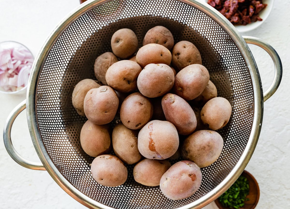 Multiple potatoes in a colander.