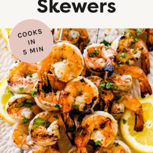 Grilled Shrimp Skewers with lemon on a platter.