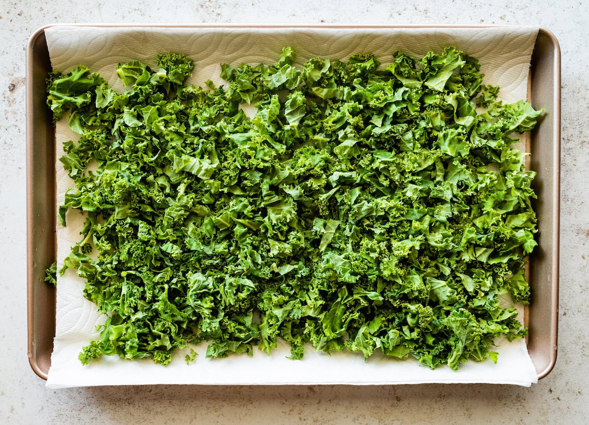 Chopped kale on top of a paper towel in a large pan.