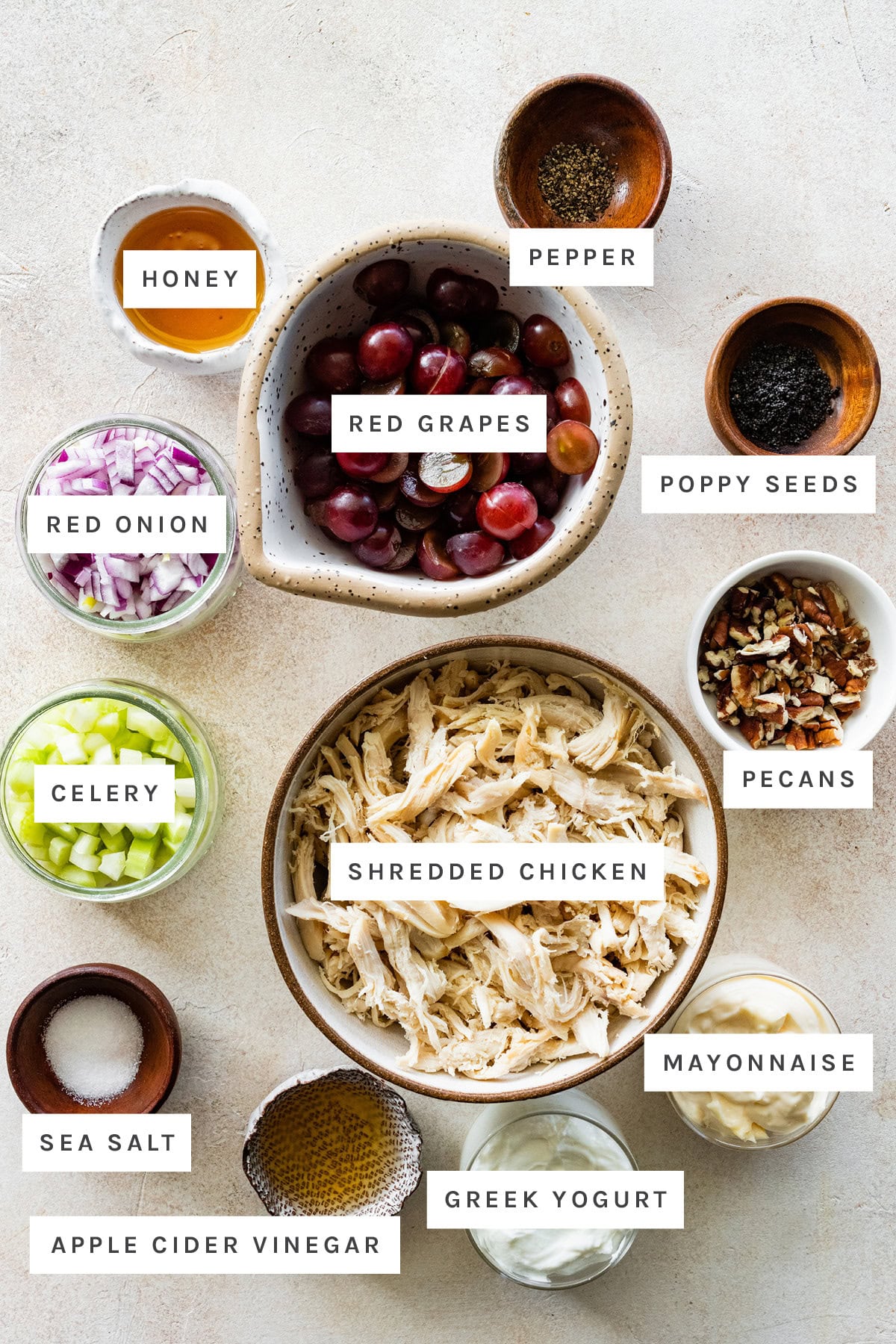 Ingredients used for sonoma chicken salad include: red grapes, shredded chicken, clelery, red onion, pecans, poppy seeds, pepper, honey, mayo, salt, vinegar, and greek yogurt.