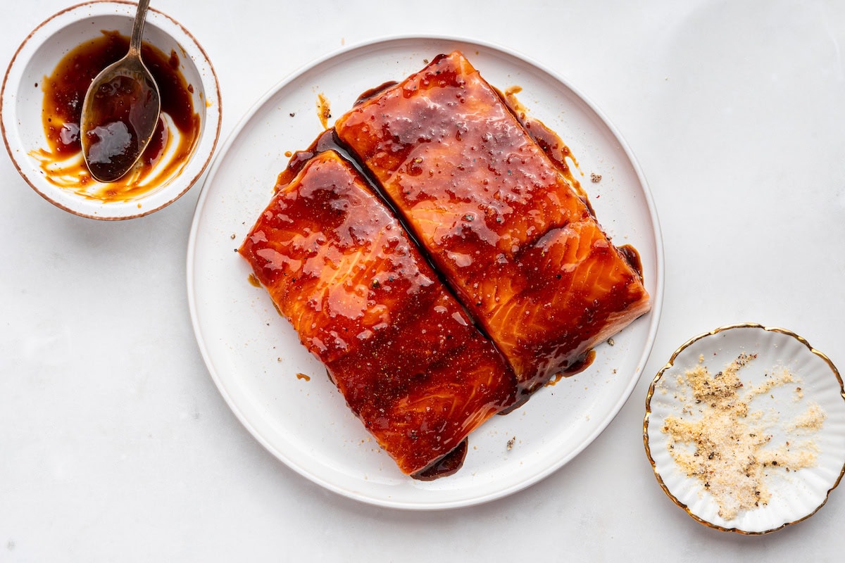 Two seasoned salmon filets with a date syrup added to them.