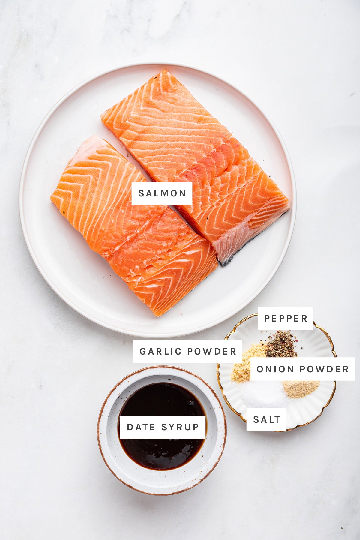 Ingredients measured out to make Air Fryer Date Glazed Salmon: salmon, garlic powder, pepper, onion powder, salt and date syrup.