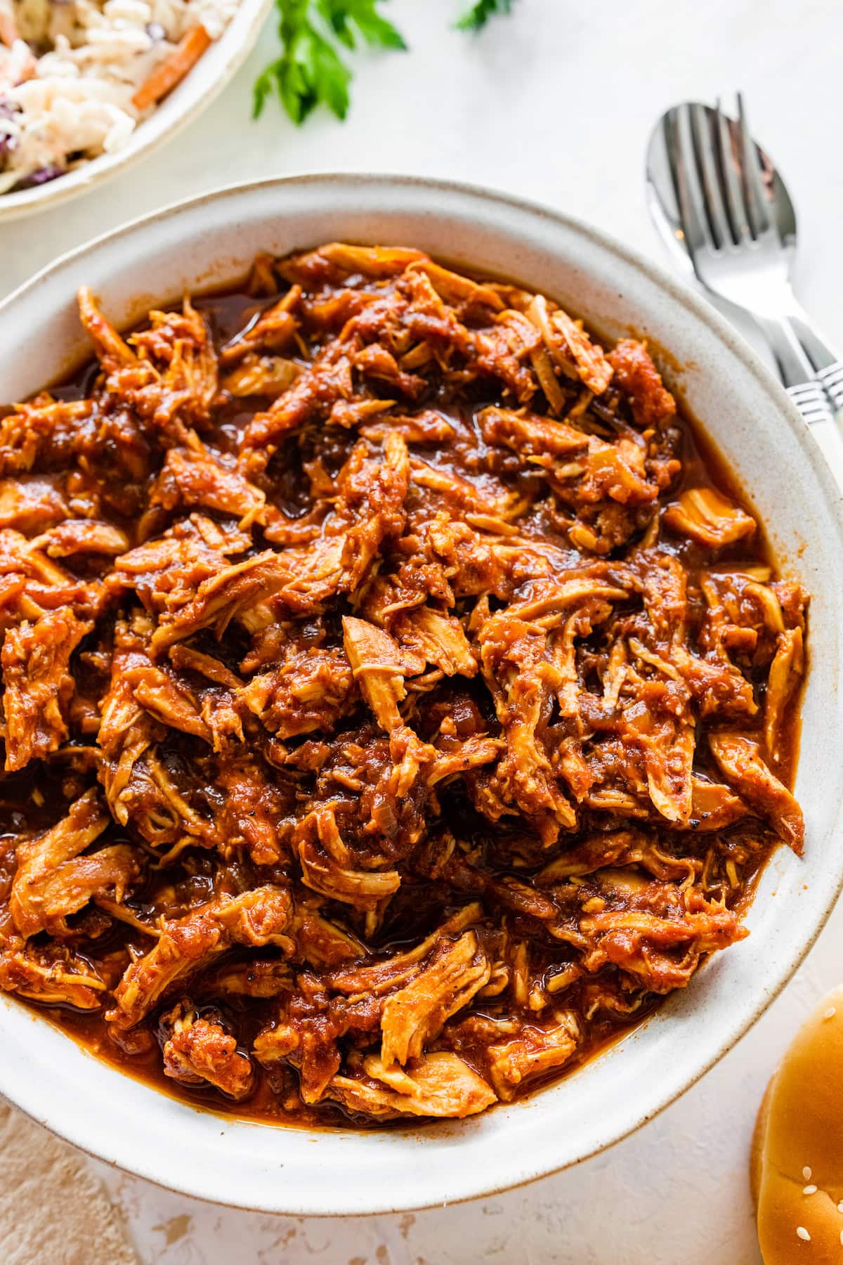 A large bowl full of BBQ shredded chicken.