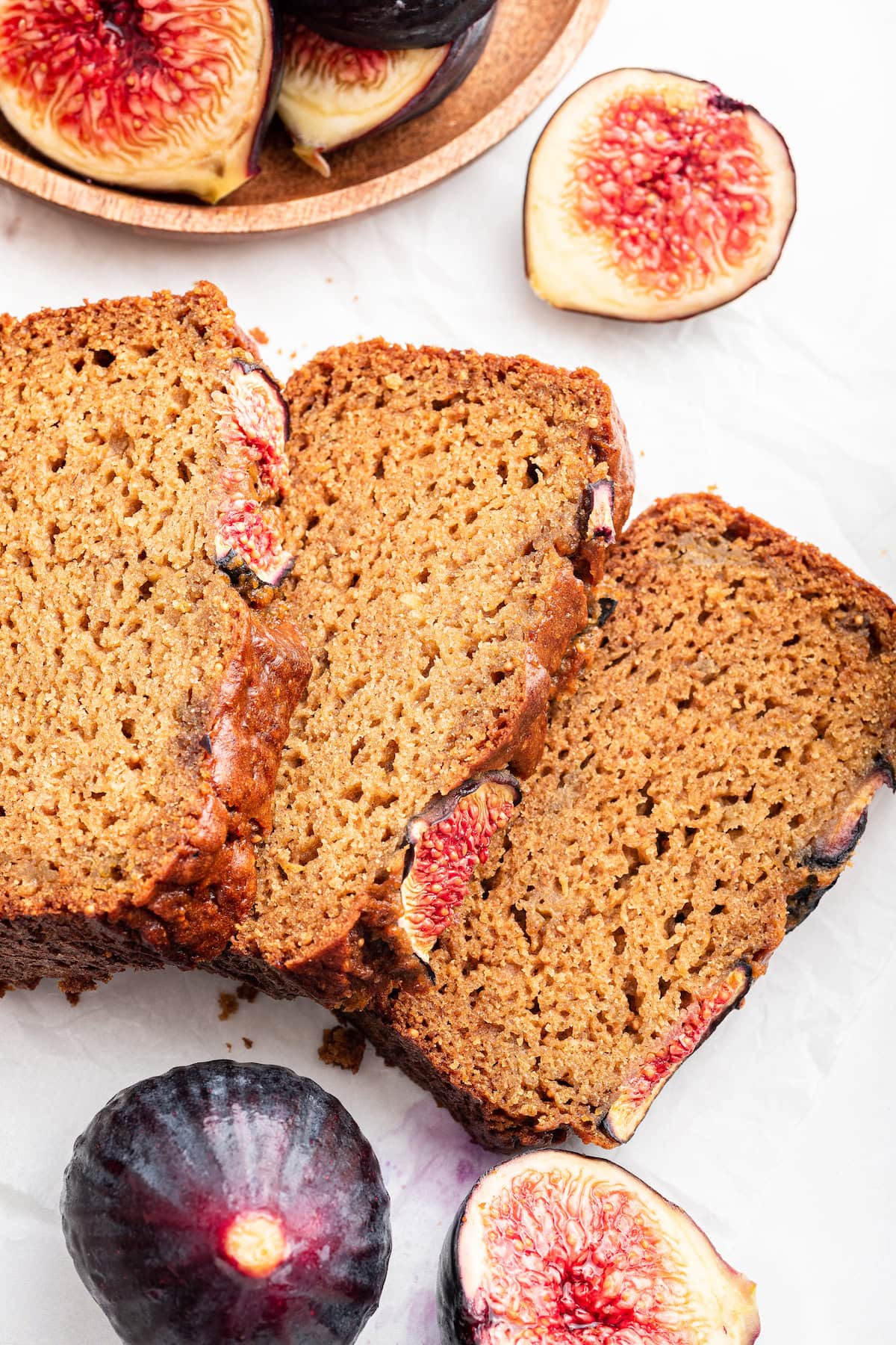 Three slices of fig bread leaning against one another.