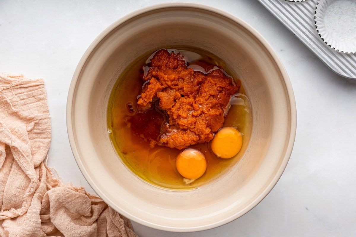A large bowl of pumpkin puree, eggs, honey, and vanilla.