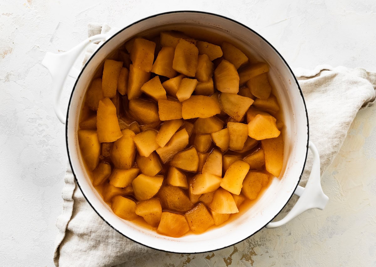 Cinnamon apple chunks in a large pot.