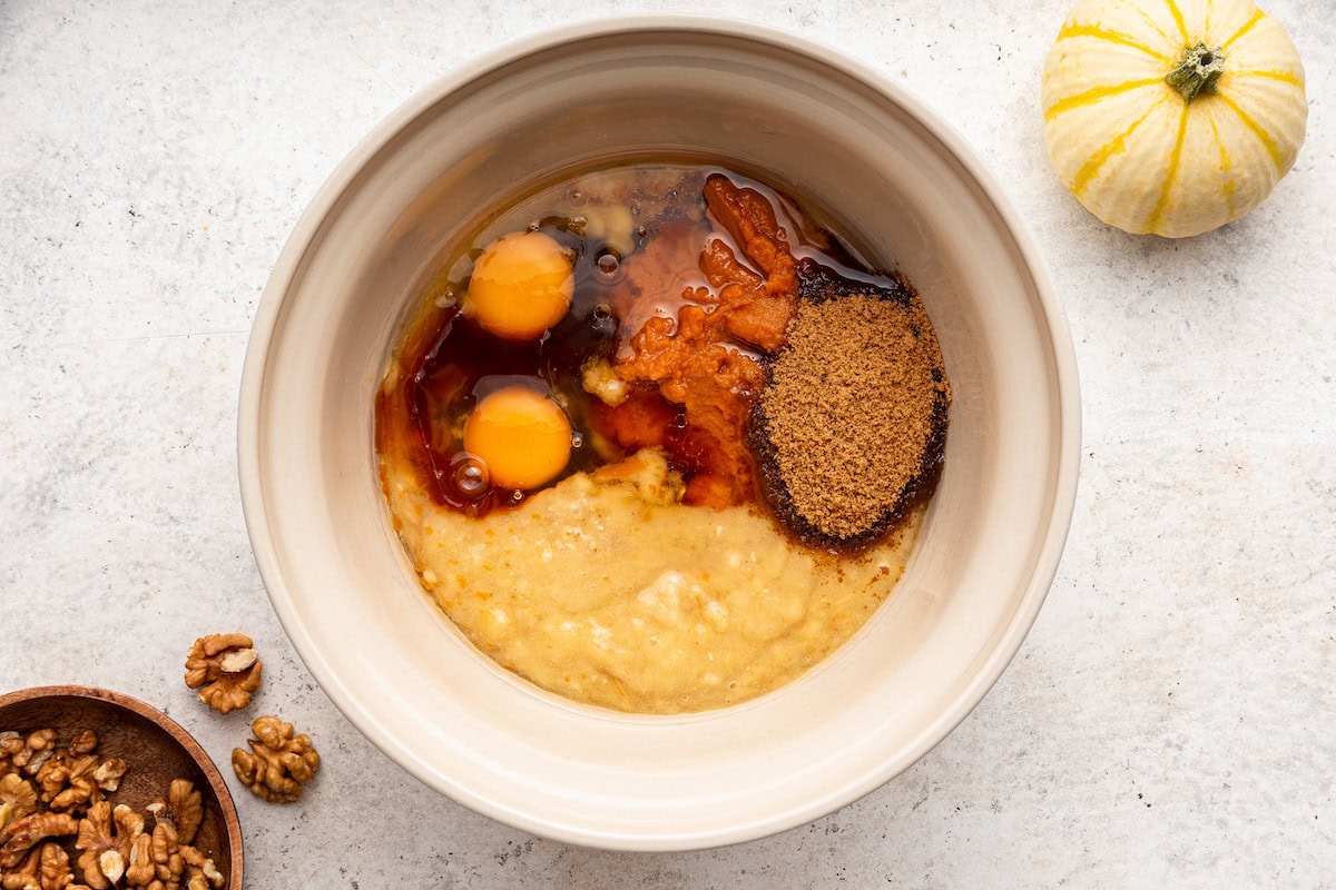 Wet ingredients used for pumpkin banana bread in a large bowl.