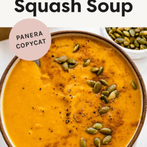 Autumn Squash Soup in a bowl topped with pepitas, pepper and cinnamon.