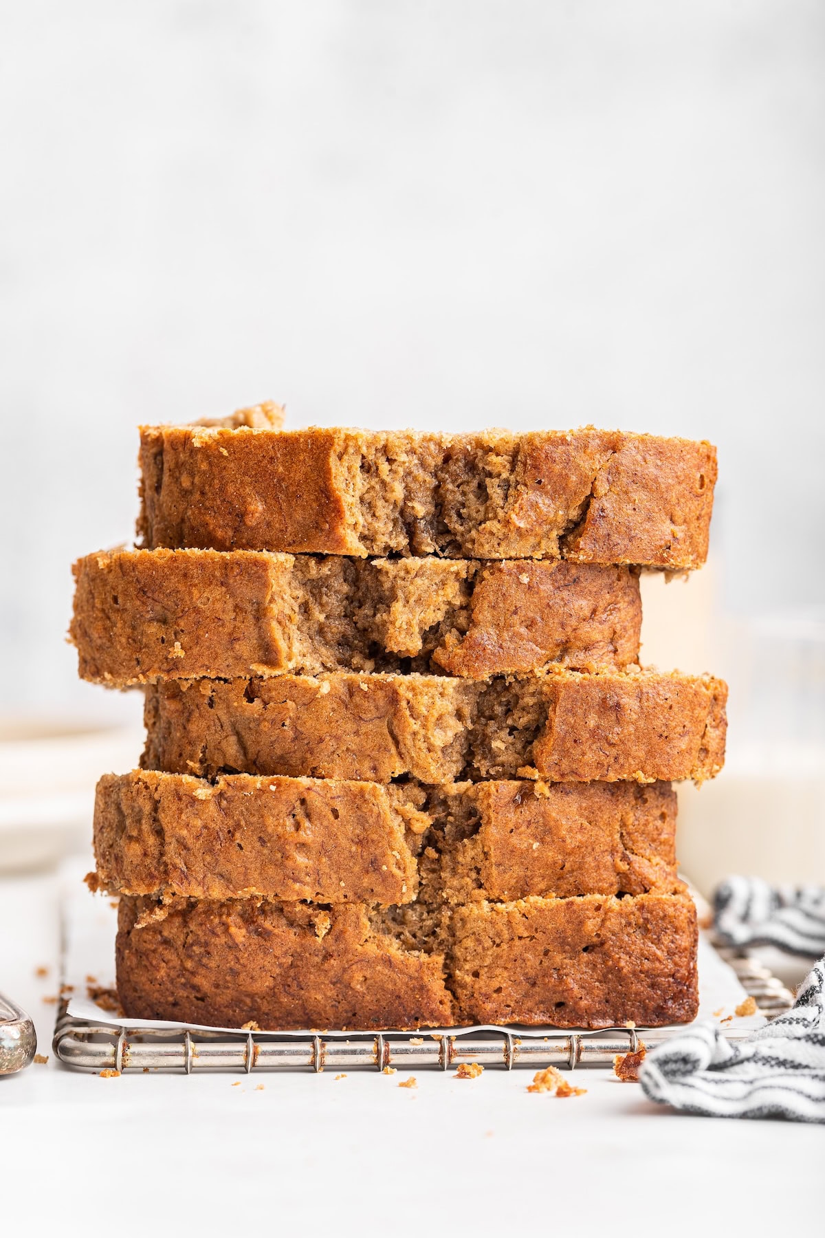Five slices of oat flour banana bread stacked on one another.