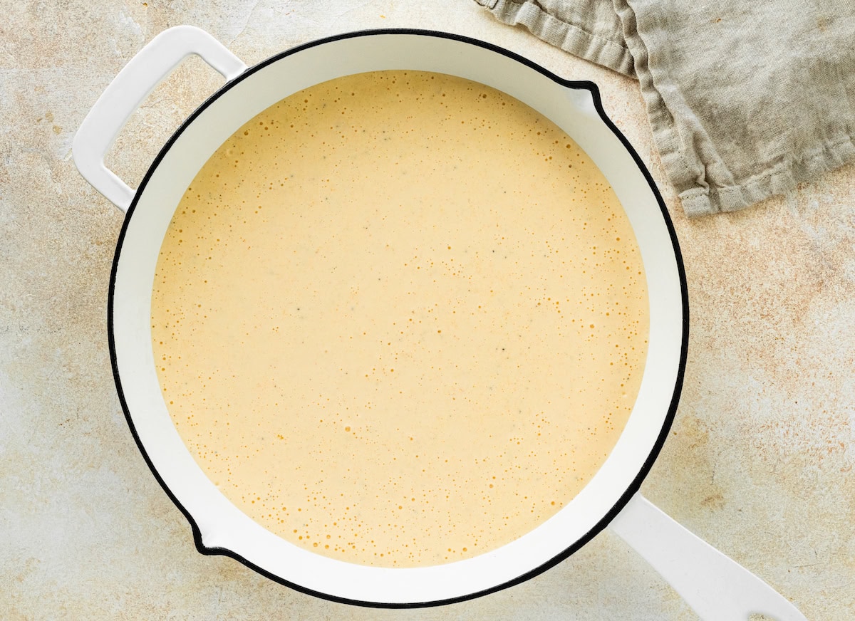 A cottage cheese sauce in a pan used for mac and cheese.