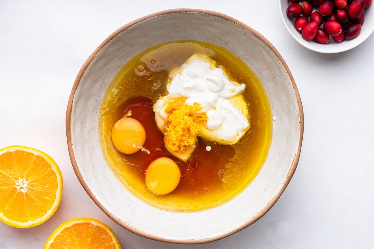 Eggs, maple syrup, greek yogurt, oil, orange juice, orange zest and vanilla in a large mixing bowl.