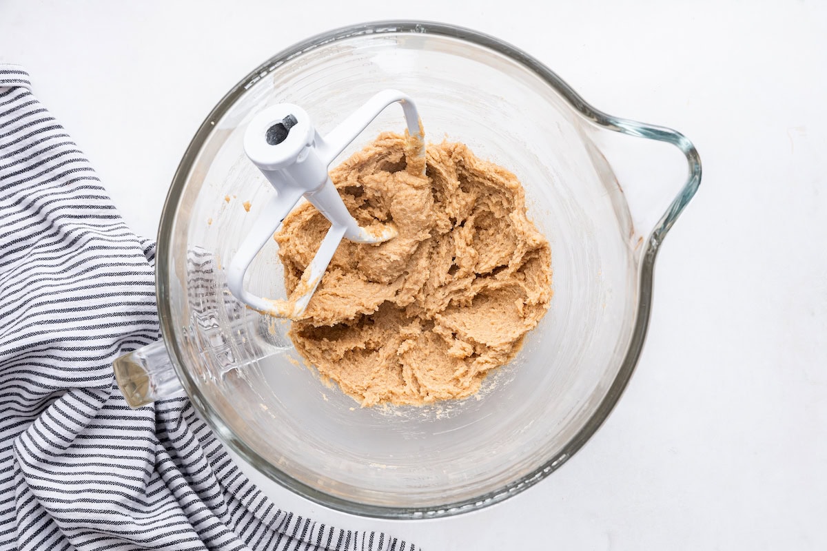 The wet ingredients for the molasses cookies mixed together in a glass bowl.