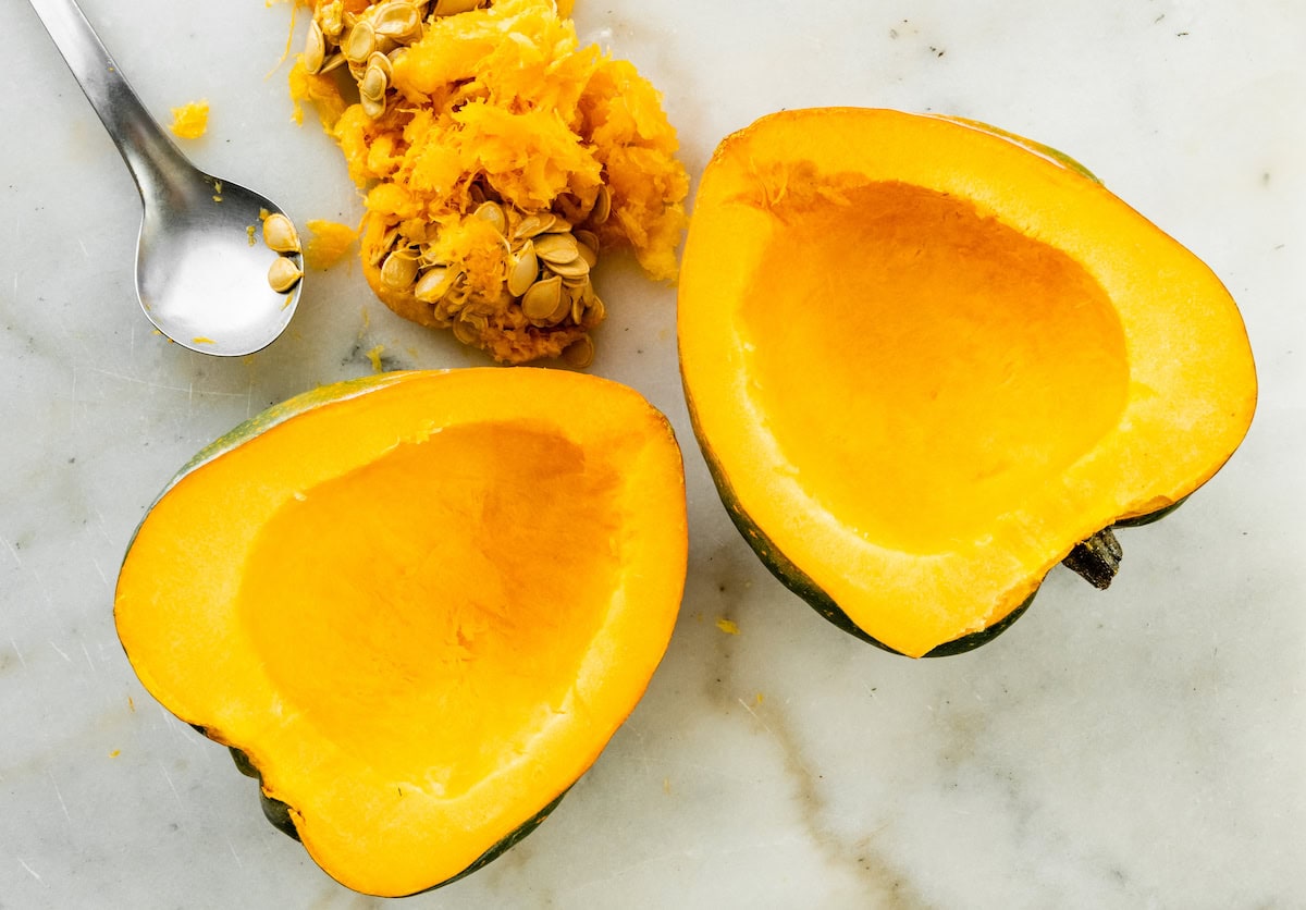 An acorn squash cut in half with the seeds removed.