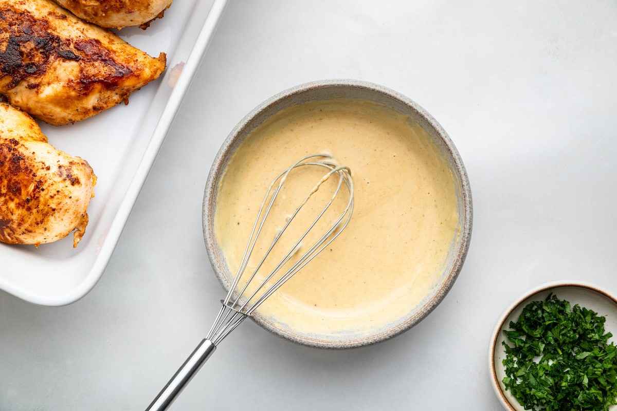 A honey mustard sauce combined in a small ceramic bowl.