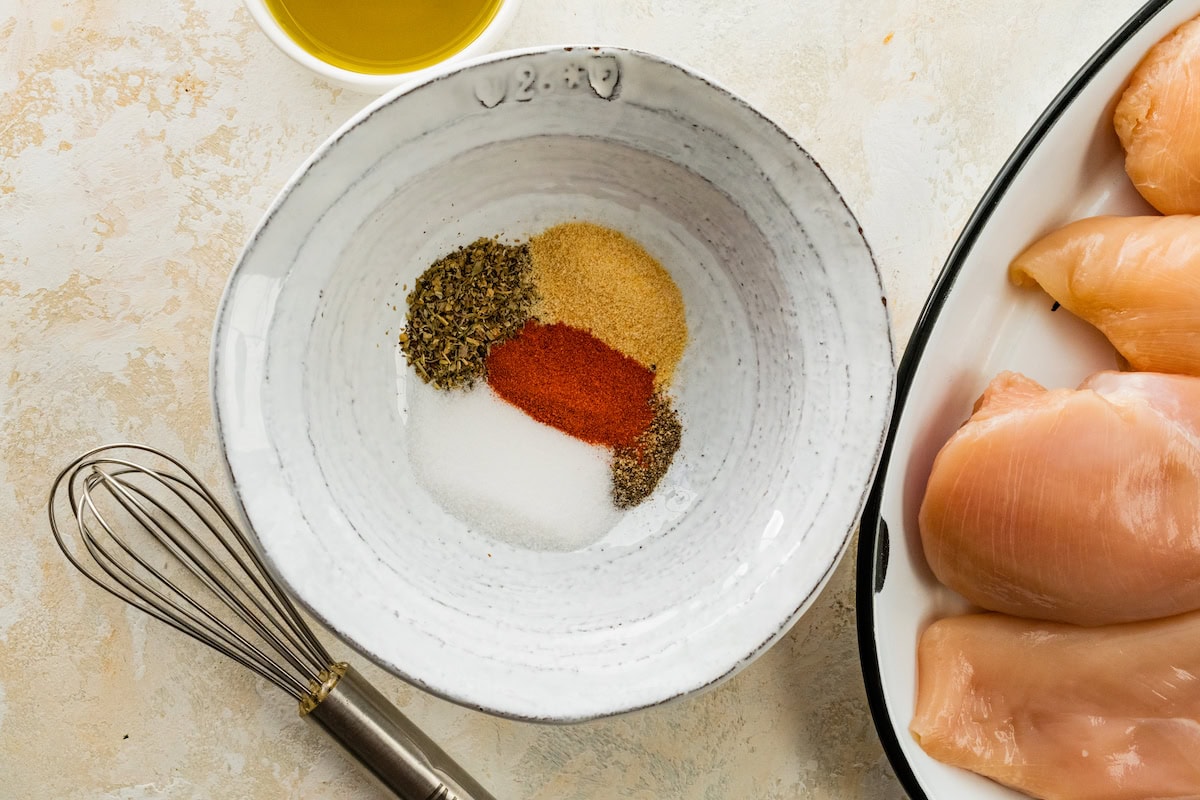A small bowl of salt, paprika, garlic powder, Italian seasoning and pepper.