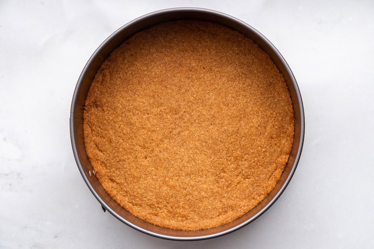 The baked crust for the healthy cheesecake in a springform pan.