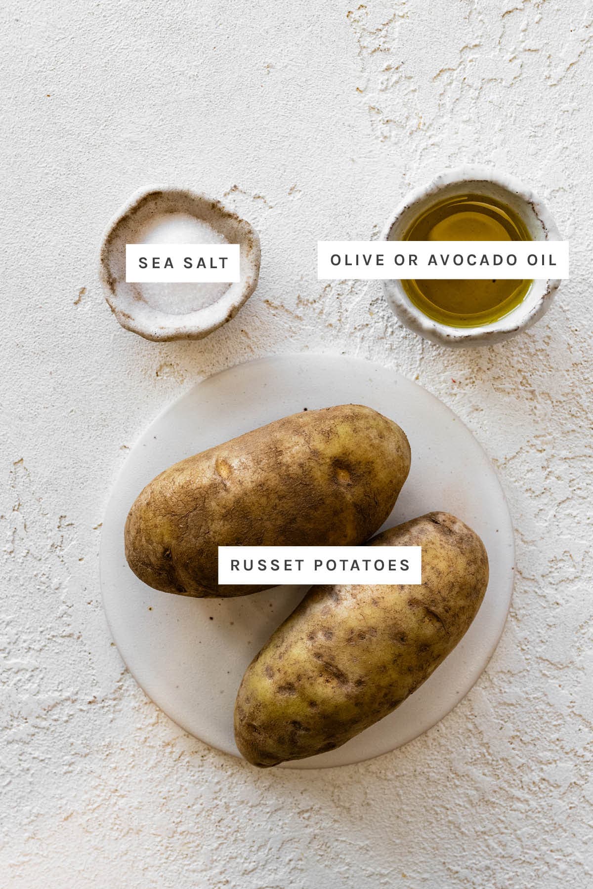 Ingredients measured out to make Air Fryer French Fries: sea salt, olive oil and russet potatoes.
