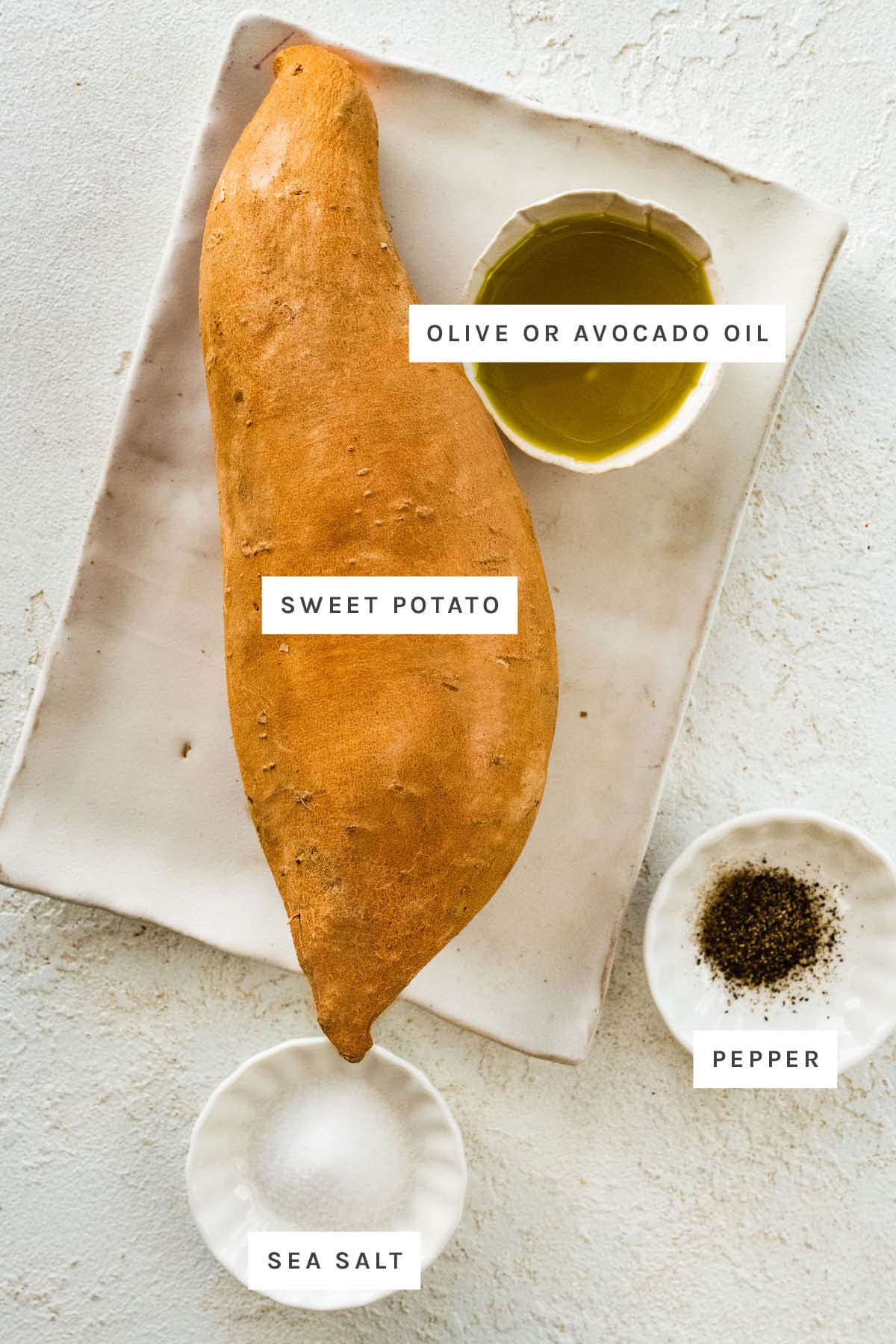 Ingredients measured out to make Air Fryer Sweet Potato Fries: Sweet Potato, olive oil, sea salt and pepper.