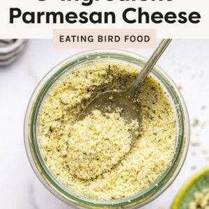 Glass jar of Vegan Parmesan Cheese with a spoon.
