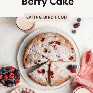 An overhead photo of berry cake cut up on a plate with berries on top.